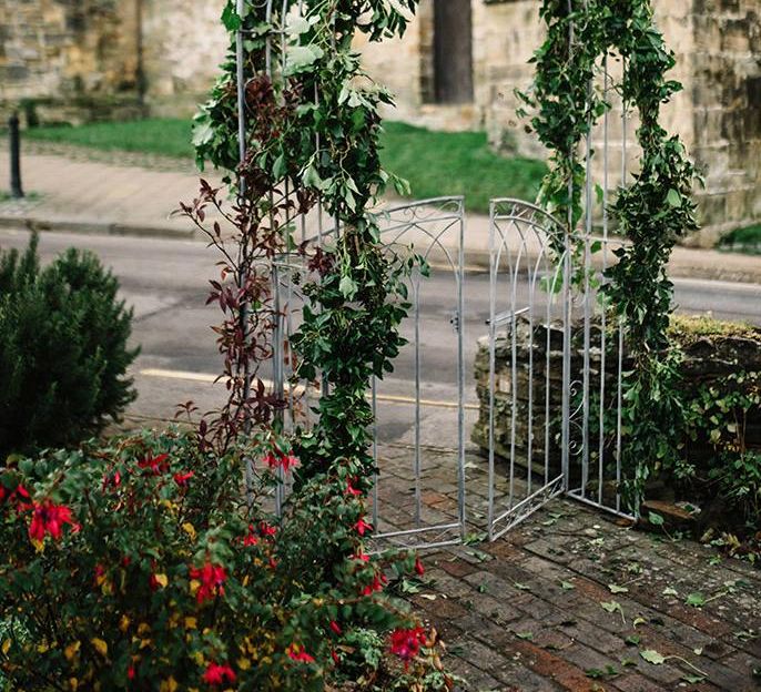 Archway with foliage decor at East Sussex venue for winter celebration