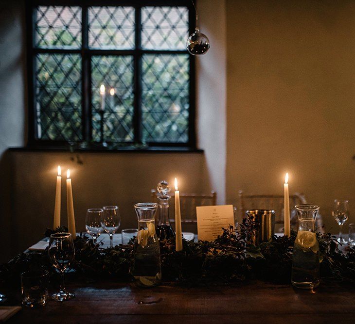 Table plan styling at gothic wedding with candlelights and foliage decor