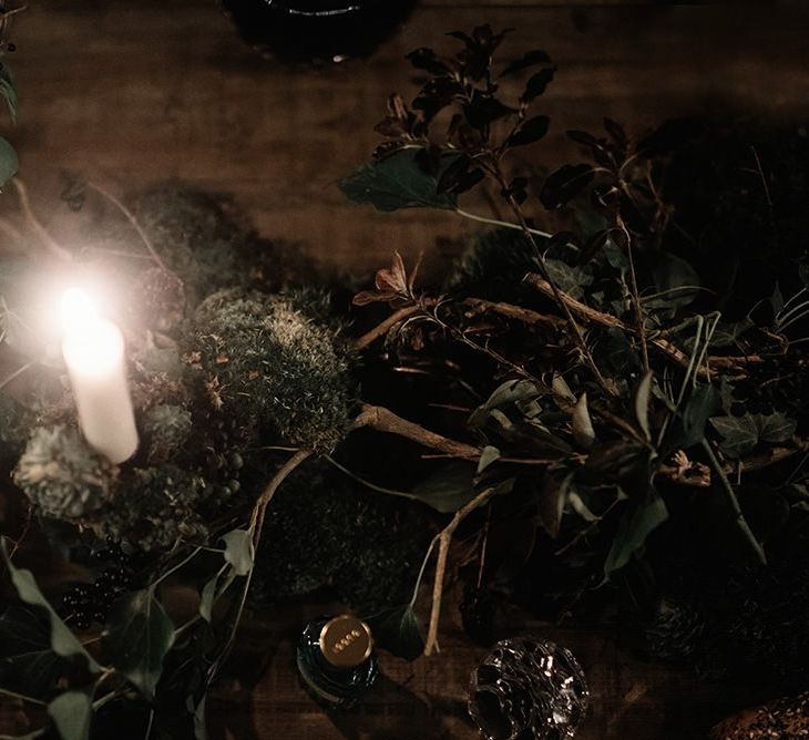 Foliage decor details with candlelight for intimate and cosy reception