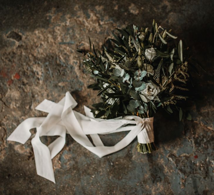 Wedding Bouquet of White Flowers and Green Foliage with White Trailing Ribbon | Festoon Light Canopy and Indoor Trees for Humanist Wedding in St Andrews | Carla Blain Photography