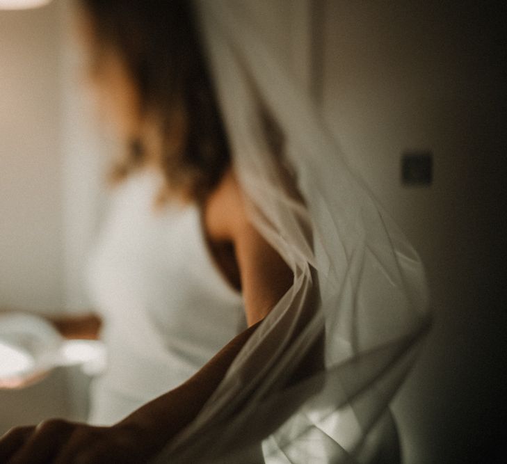 Bride in Anne Priscilla Signature Gown with Halterneck, Keyhole Back and Belt | Floor Length Veil | Festoon Light Canopy and Indoor Trees for Humanist Wedding in St Andrews | Carla Blain Photography