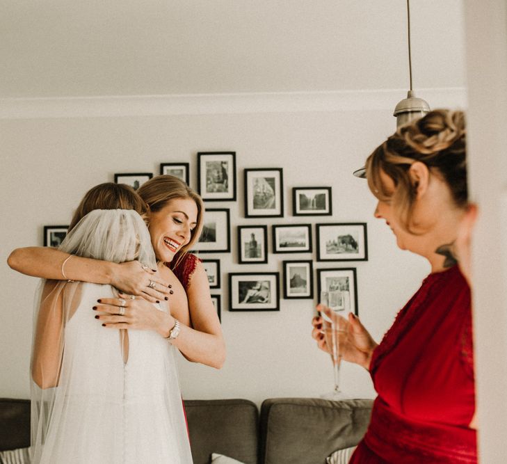 Bride in Anne Priscilla Signature Gown with Halterneck, Keyhole Back and Belt | Floor Length Veil | Bridesmaids in Maroon ASOS Dresses with Lace Cap Sleeves, Halterneck and Leg Split | Festoon Light Canopy and Indoor Trees for Humanist Wedding in St Andrews | Carla Blain Photography