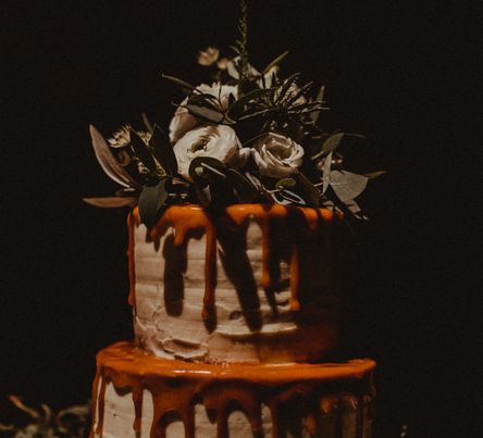 Two-Tier Drip Wedding Cake Decorated with White Flowers and Green Foliage | Festoon Light Canopy and Indoor Trees for Humanist Wedding in St Andrews | Carla Blain Photography