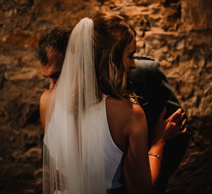 Bride in Anne Priscilla Signature Gown with Halterneck, Keyhole Back and Belt | Floor Length Veil | Groom in Mackintosh Tartan Red and Black Kilt with Green Jacket and Waistcoat | Festoon Light Canopy and Indoor Trees for Humanist Wedding in St Andrews | Carla Blain Photography