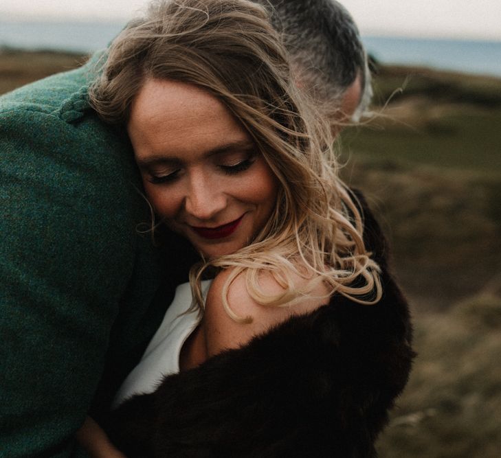 Bride in Anne Priscilla Signature Gown with Halterneck, Keyhole Back and Belt | Groom in Mackintosh Tartan Red and Black Kilt with Green Jacket and Waistcoat | Festoon Light Canopy and Indoor Trees for Humanist Wedding in St Andrews | Carla Blain Photography