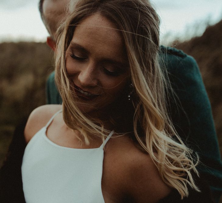 Bride in Anne Priscilla Signature Gown with Halterneck, Keyhole Back and Belt | Groom in Mackintosh Tartan Red and Black Kilt with Green Jacket and Waistcoat | Festoon Light Canopy and Indoor Trees for Humanist Wedding in St Andrews | Carla Blain Photography