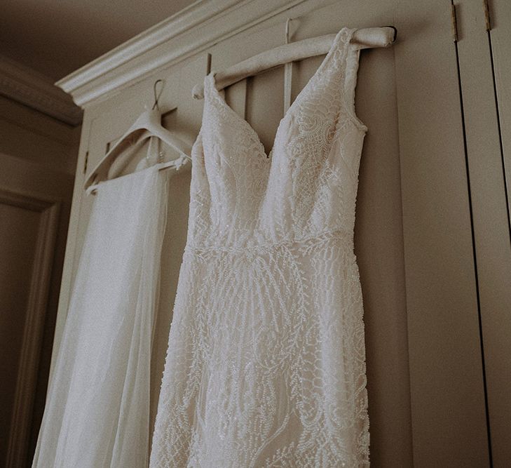 Full Lace Wedding Dress with Veil Hanging Up Before Ceremony