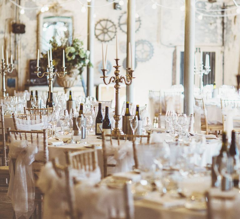 Wedding Reception Décor | Gold Candelabras | White Tapered Candles | White Material Chair Sashes | Festoon Lights | Oversized Floral Urn | Lace Bridal Cape Veil &amp; Fishtail Wedding Dress by Pronovias | On Love and Photography