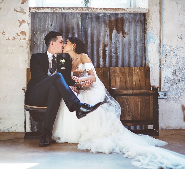 Bride in Fishtail Pronovias Wedding Dress with Off Shoulder Sleeves and Veil Cape | Groom in Navy Tails and Grey Waistcoat | Bride Wearing Hair Down | Lace Bridal Cape Veil &amp; Fishtail Wedding Dress by Pronovias | On Love and Photography