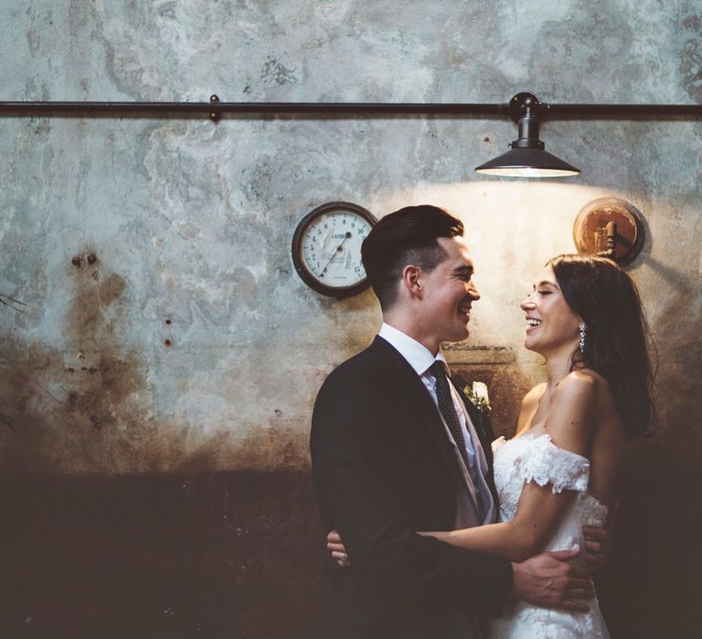 Bride in Fishtail Pronovias Wedding Dress with Off Shoulder Sleeves and Veil Cape | Groom in Navy Tails and Grey Waistcoat | Bride Wearing Hair Down | Lace Bridal Cape Veil &amp; Fishtail Wedding Dress by Pronovias | On Love and Photography