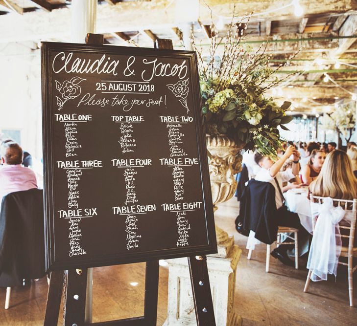 Chalkboard Wedding Seating Plan | Oversized Floral Urn | Lace Bridal Cape Veil &amp; Fishtail Wedding Dress by Pronovias | On Love and Photography