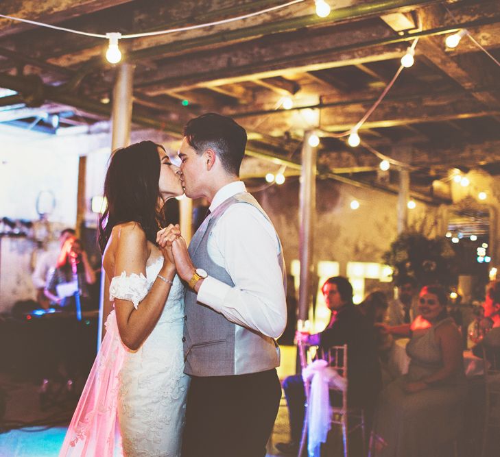 First Dance | Bride in Fishtail Pronovias Wedding Dress with Off Shoulder Sleeves and Veil Cape | Groom in Navy Tails and Grey Waistcoat | Bride Wearing Hair Down | Festoon Lights | Lace Bridal Cape Veil &amp; Fishtail Wedding Dress by Pronovias | On Love and Photography