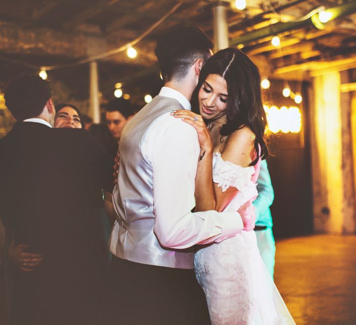 First Dance | Bride in Fishtail Pronovias Wedding Dress with Off Shoulder Sleeves and Veil Cape | Groom in Navy Tails and Grey Waistcoat | Bride Wearing Hair Down | Festoon Lights | Lace Bridal Cape Veil &amp; Fishtail Wedding Dress by Pronovias | On Love and Photography