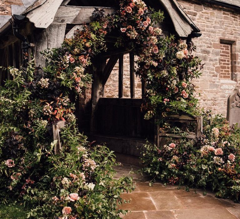 Beautiful wedding flowers at church entrance