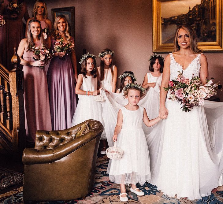 Bride with flower girls and pink bridesmaid dresses