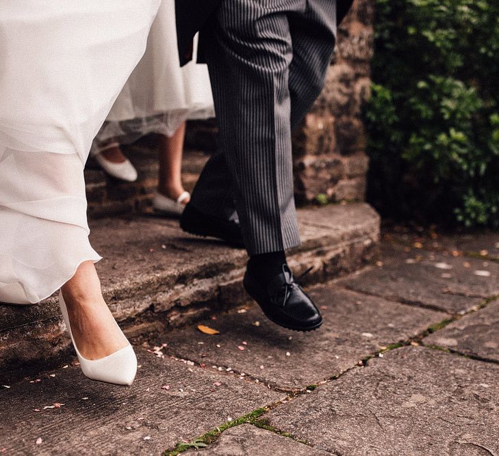 White wedding shoes for bride at Dewsall Court