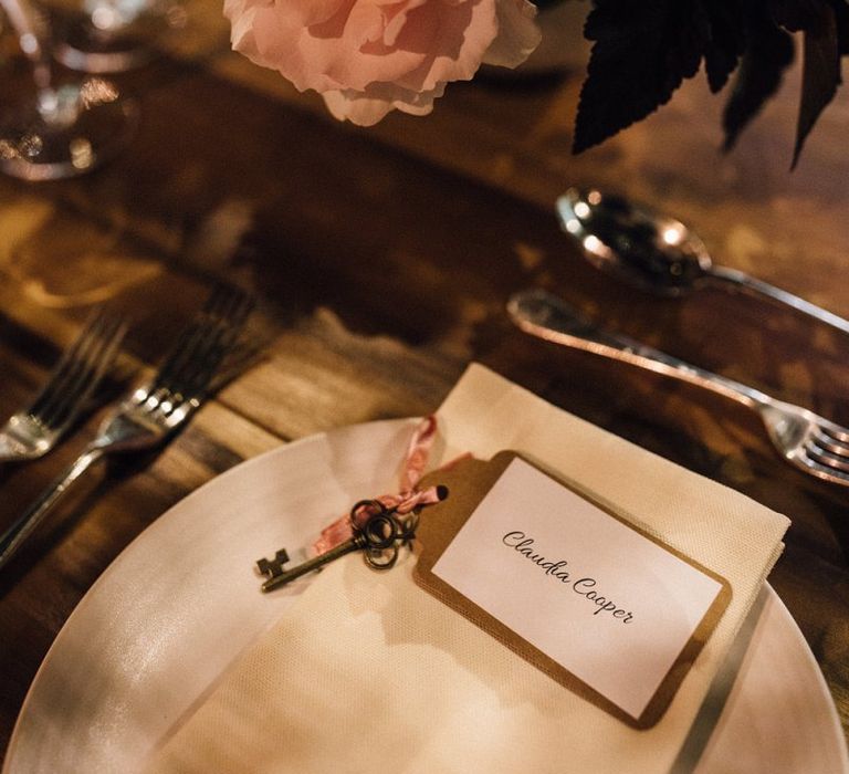 Wedding place setting with key and pink flowers