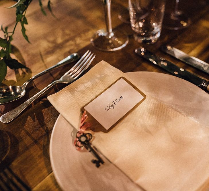 Wedding place setting with key and pink flowers