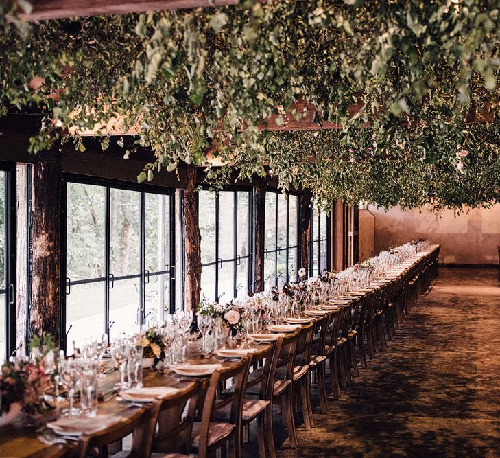 Hanging foliage wedding breakfast decor at Dewsall Court