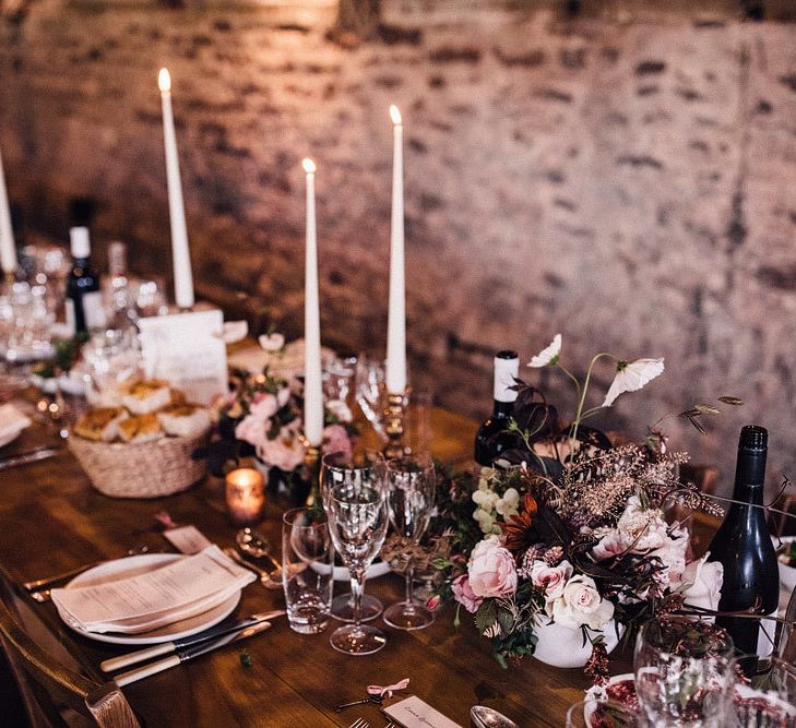 Tall candles and blush flowers for wedding table decor at Dewsall Court