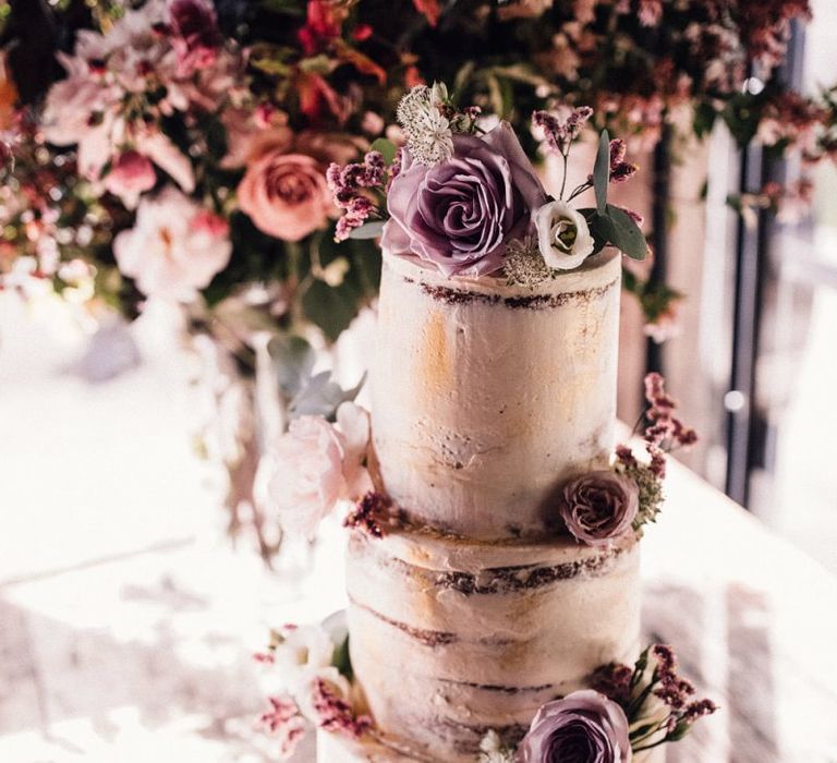 Semi-naked wedding cake with pink flower decor