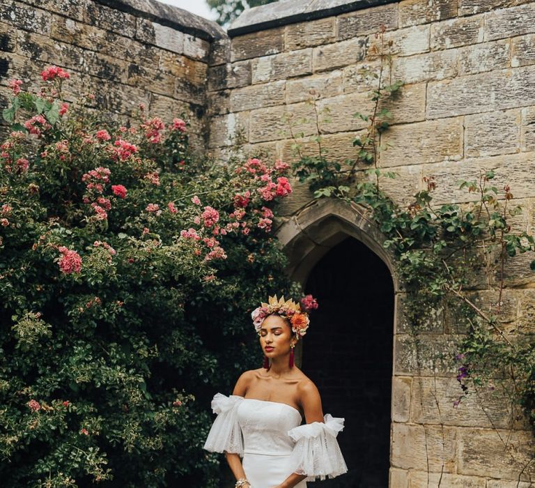 Beautiful bride in strapless wedding dress with tulle sleeves in flower crown