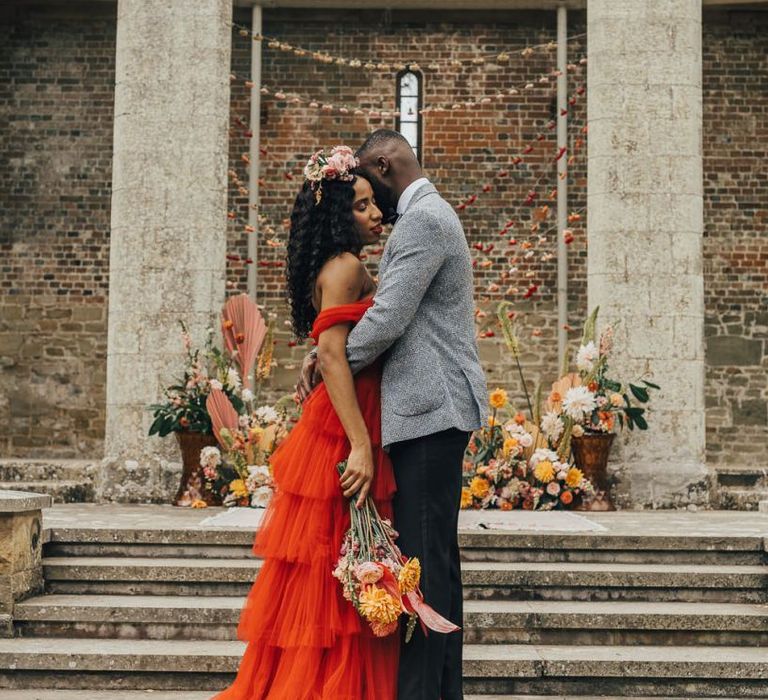 Stylish bride and groom embracing at Chiddingstone Castle