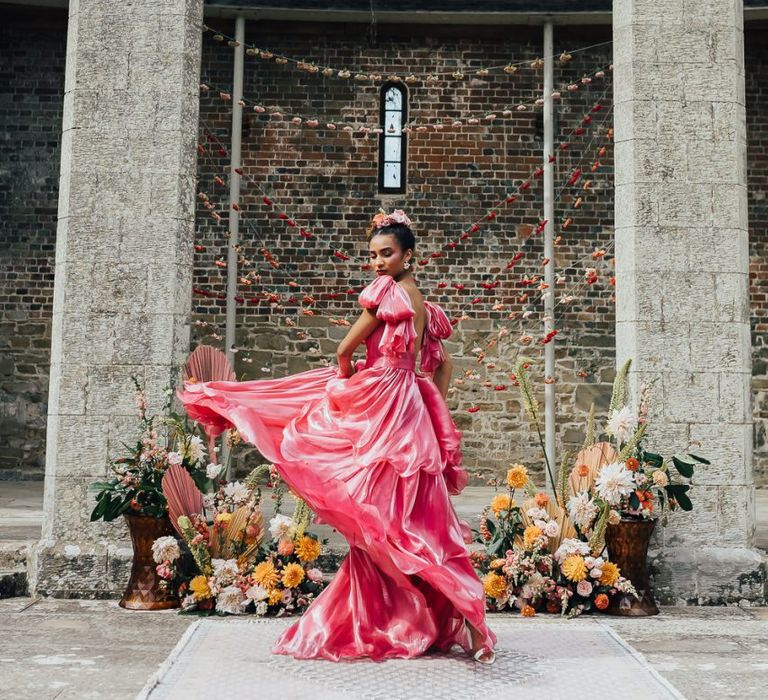 bride in bright pink Emma Beaumont wedding dress at Chiddingstone Castle