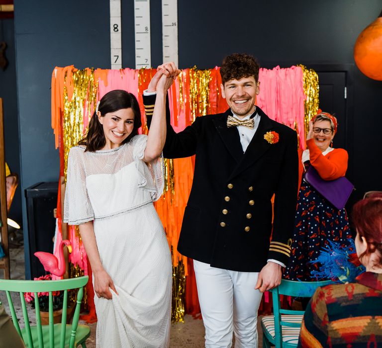 colourful wedding theme for ceremony at a boat shed