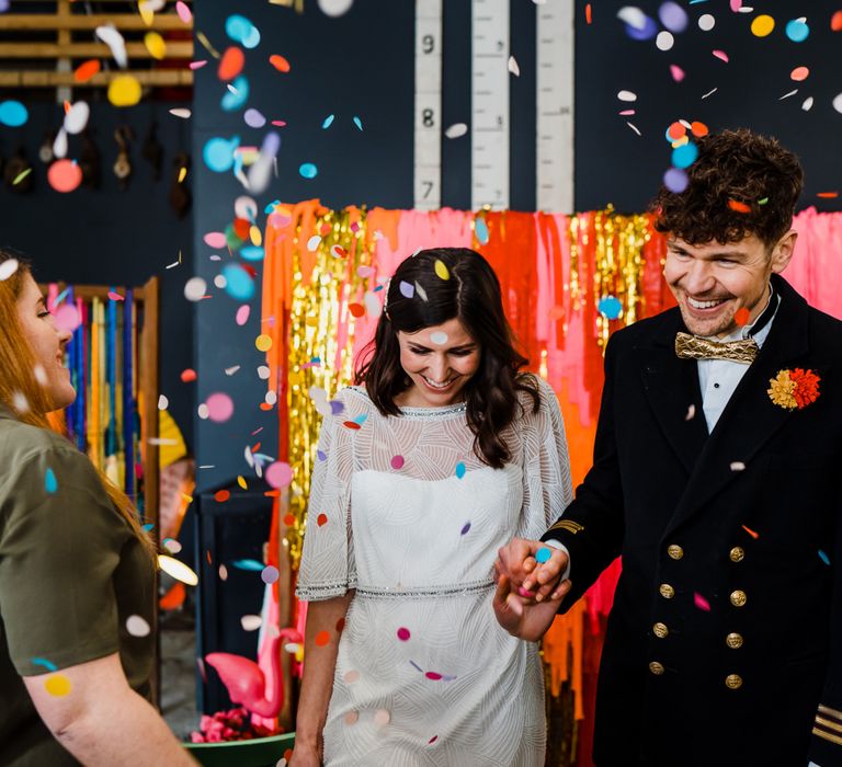 Confetti moment at boat shed wedding with colourful wedding theme