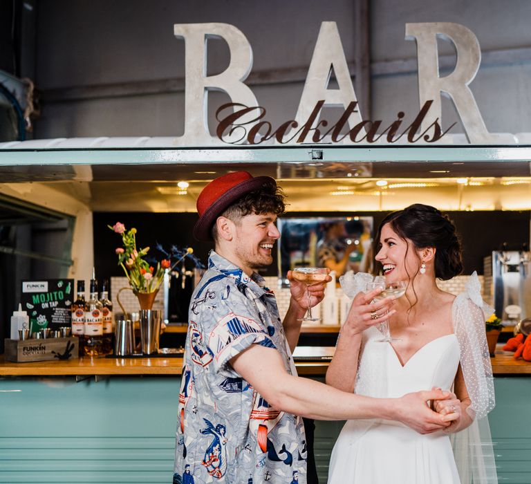 Bride and groom enjoying drinks at mobile cocktail bar