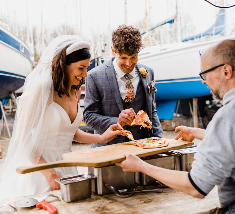 Bride and groom enjoying a pizza wedding breakfast