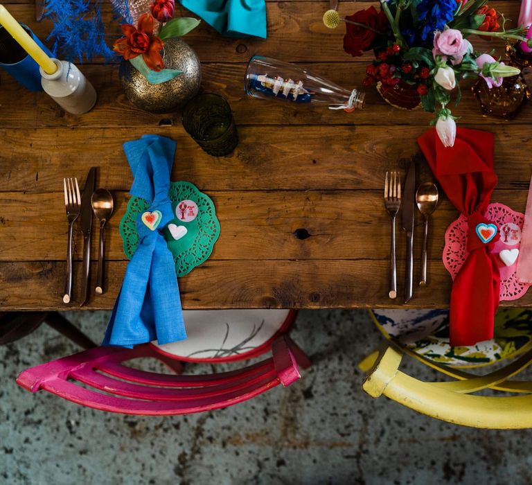 colourful wedding theme place settings with doilies, napkins and bright chairs