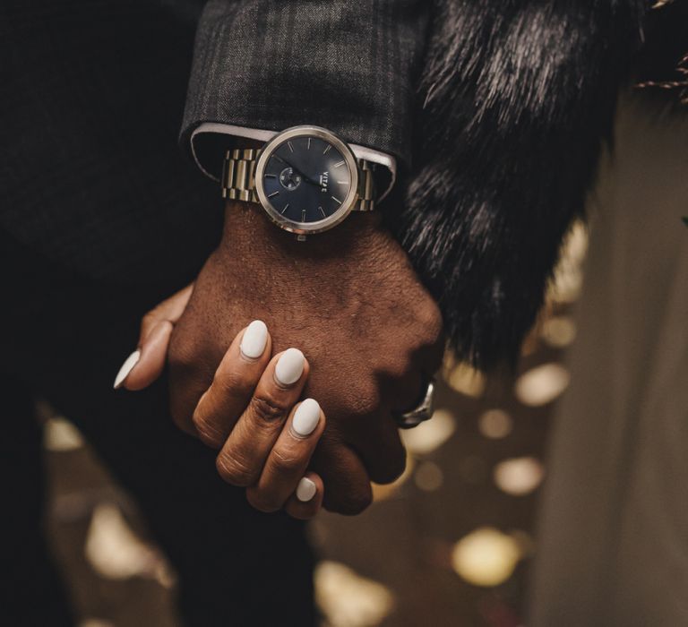 Groom wearing a Vitae watch with black face