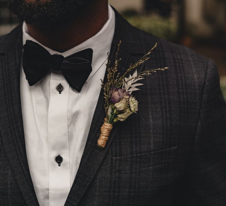 Stylish grooms buttonhole hole tied with string