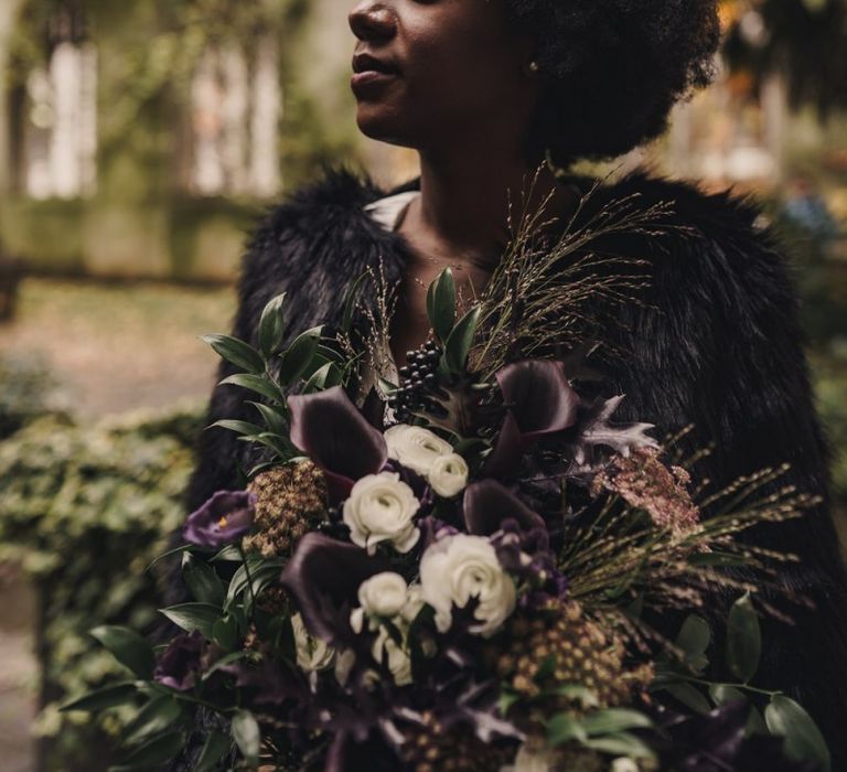 Black bride holding a purple Calla Lily wedding bouquet