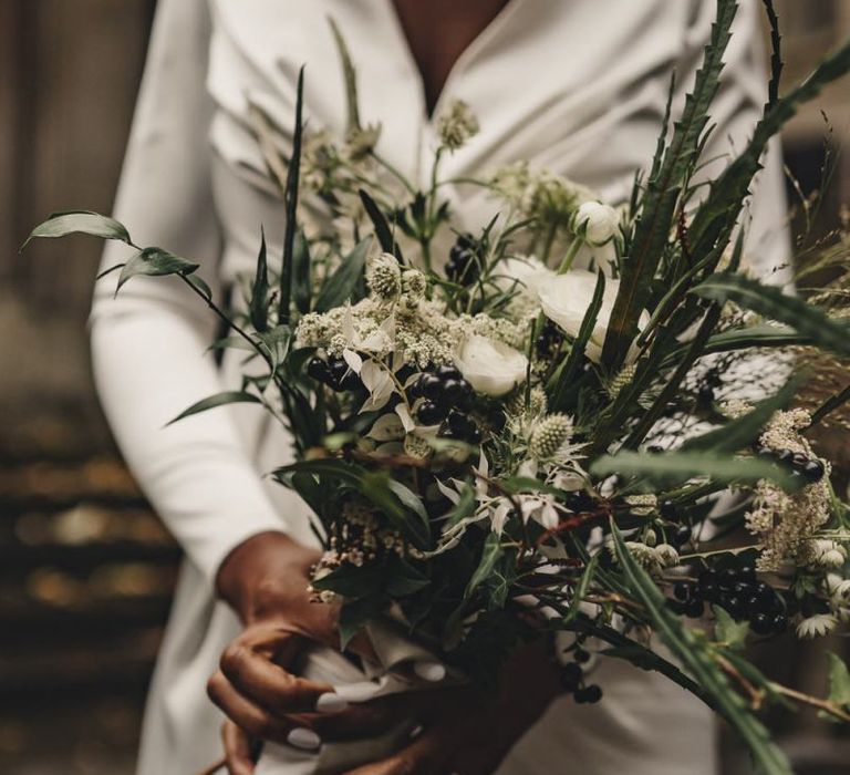 Green and white wedding bouquet tied with ribbon