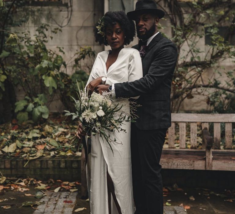 Bride and groom embracing at St Dunstan in the East gardens