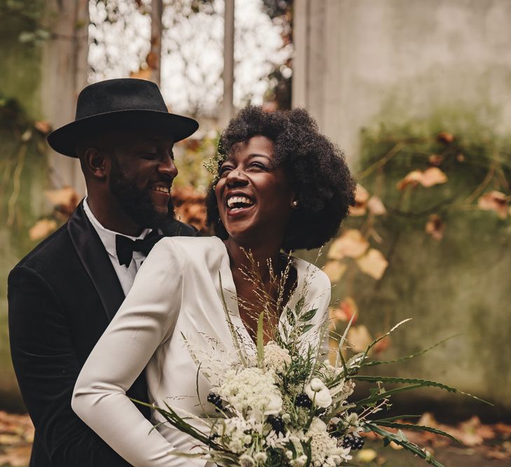 Happy bride and groom portrait at St Dunstan in the East gardens