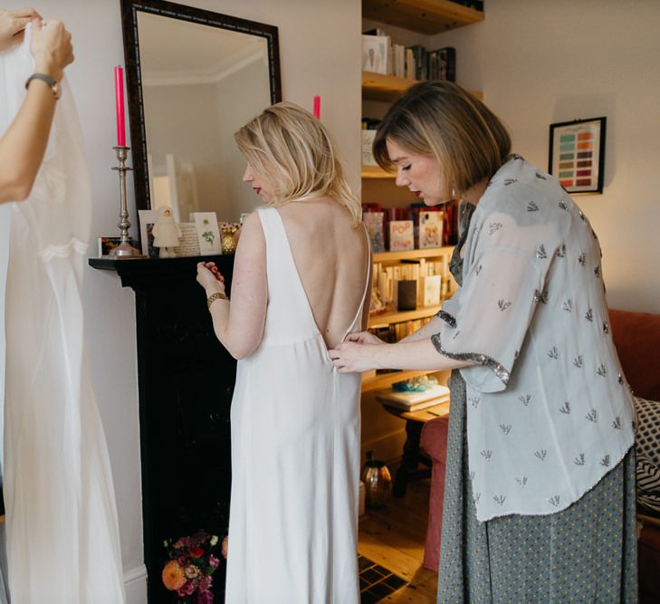 Bride getting ready in a Cathleen Jia dress for a colourful kitsch celebration in London