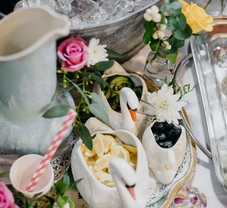 Ceramic animal pots and fun styling  for kitsch reception with pine cone wedding decor