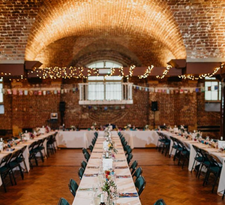 Reception styling for colourful and fun day with pine cone wedding decor