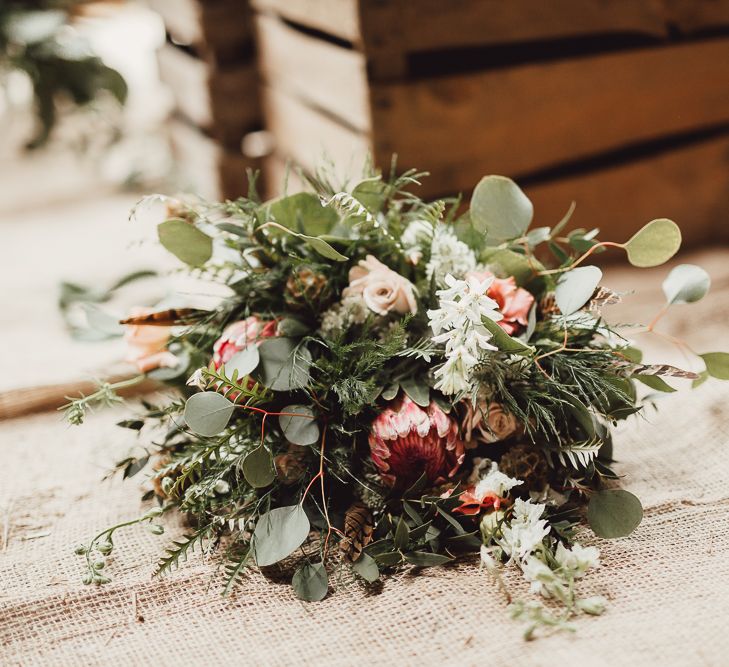 Foliage, Coral Flowers &amp; Pheasant Feather Bouquet with Proteas | Country Boho Inspiration in the Woodlands of Happy Valley Norfolk | Cara Zagni Photography