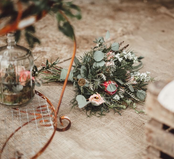 Foliage, Coral Flowers &amp; Pheasant Feather Bouquet with Proteas | Country Boho Inspiration in the Woodlands of Happy Valley Norfolk | Cara Zagni Photography