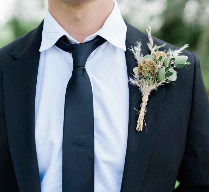 Groom in Black suit and Tie with Foliage and Pampas Grass Buttonhole