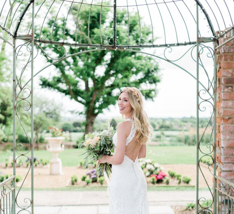 Bride in Key Hole Back Lace Watters Wedding Dress with Long Wavy Hair