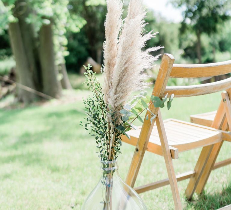 Pampas Grass and Foliage Sprigs Lining The Aisle