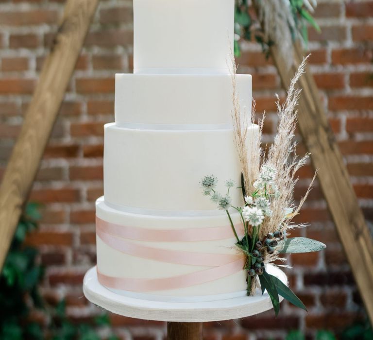 Four Tier White Wedding Cake with Ribbon and Pampas Grass Detail