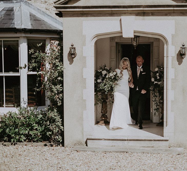 Father of the Bride and Bride in St Patrick Wedding Dress and White and Green Wedding Flowers