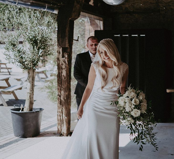 Bride in St Patrick Wedding Dress Holding White and Green Wedding Bouquet